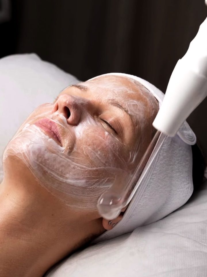 An ultrasonic treatment being carried out on a client's face at the studio.